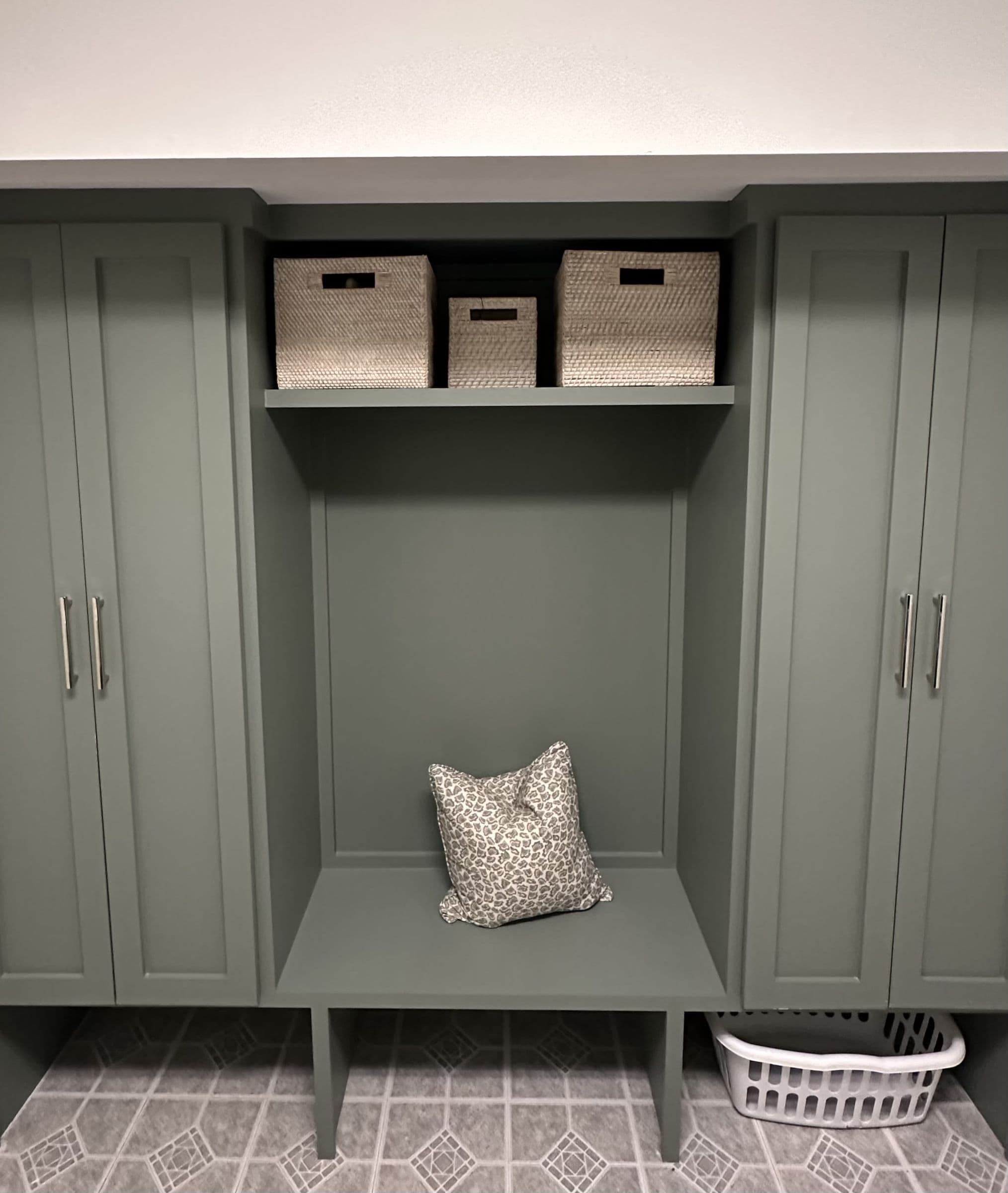 Green mudroom lockers with a bench and cubbies