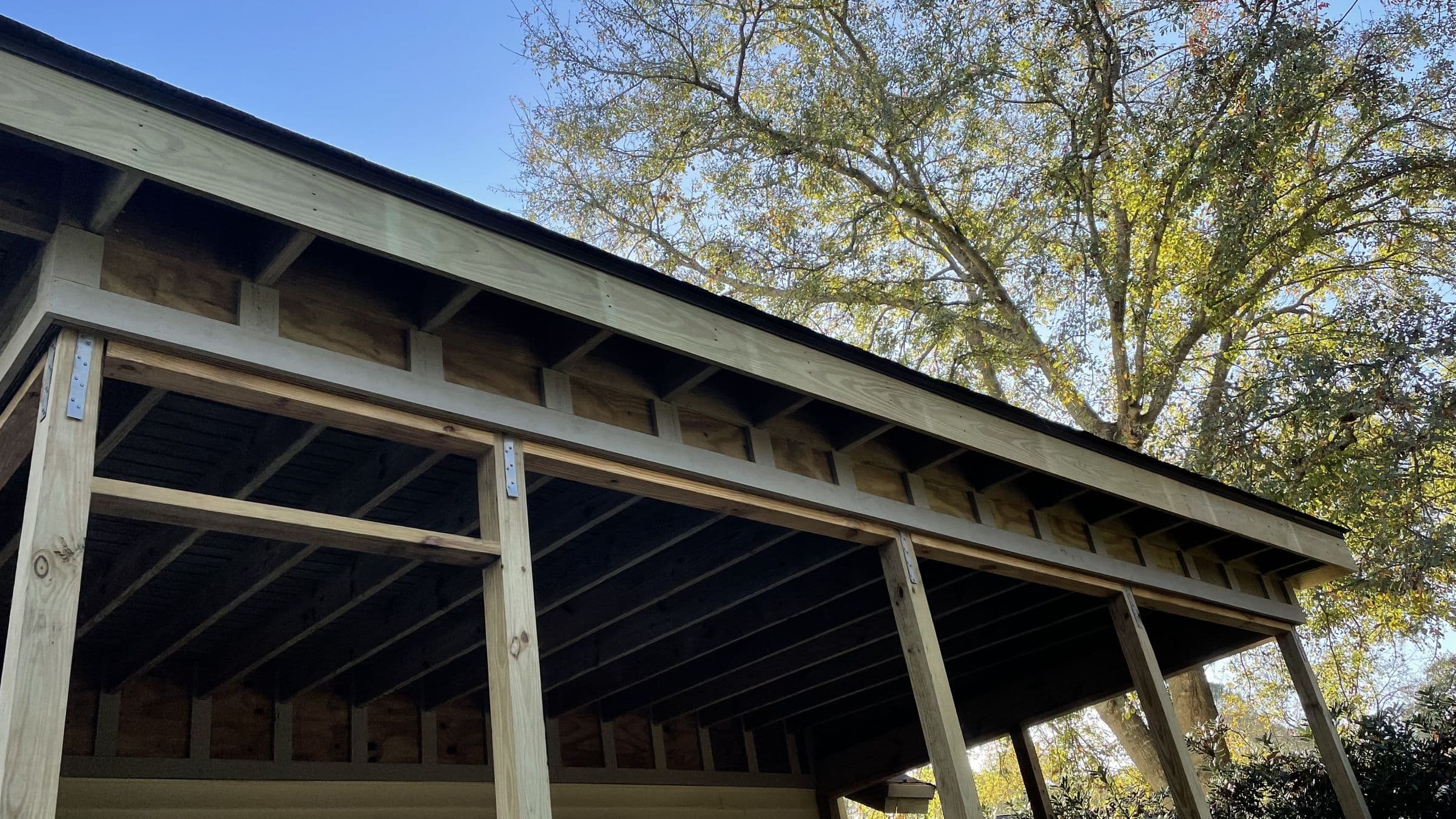 Roof framing for a porch addition under the tree canopy