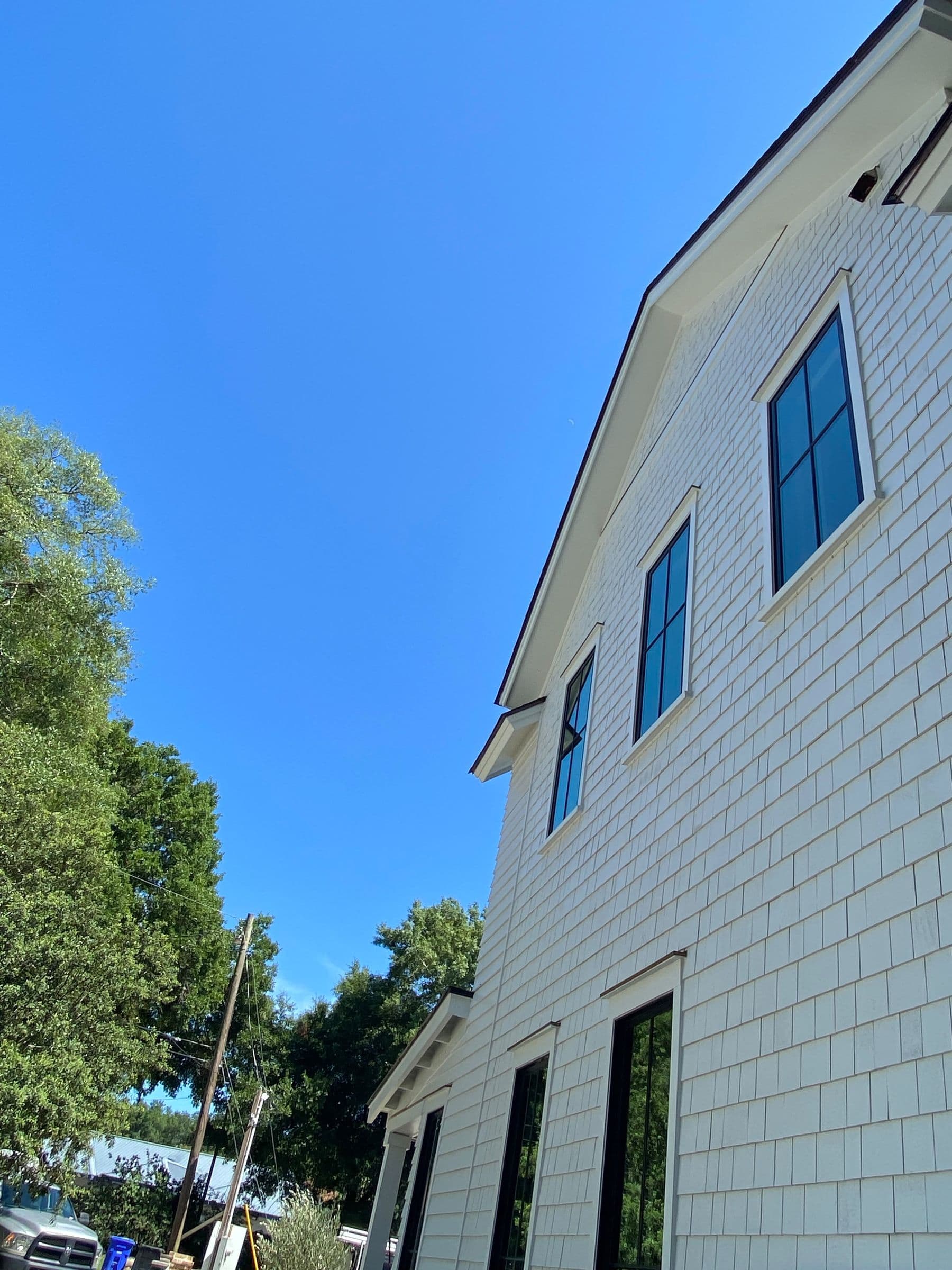 Painted shake siding and trim on a two-story house